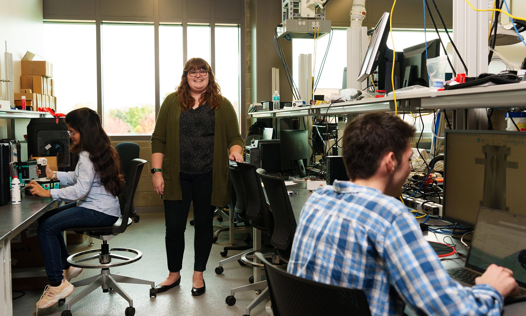 Three people in a lab